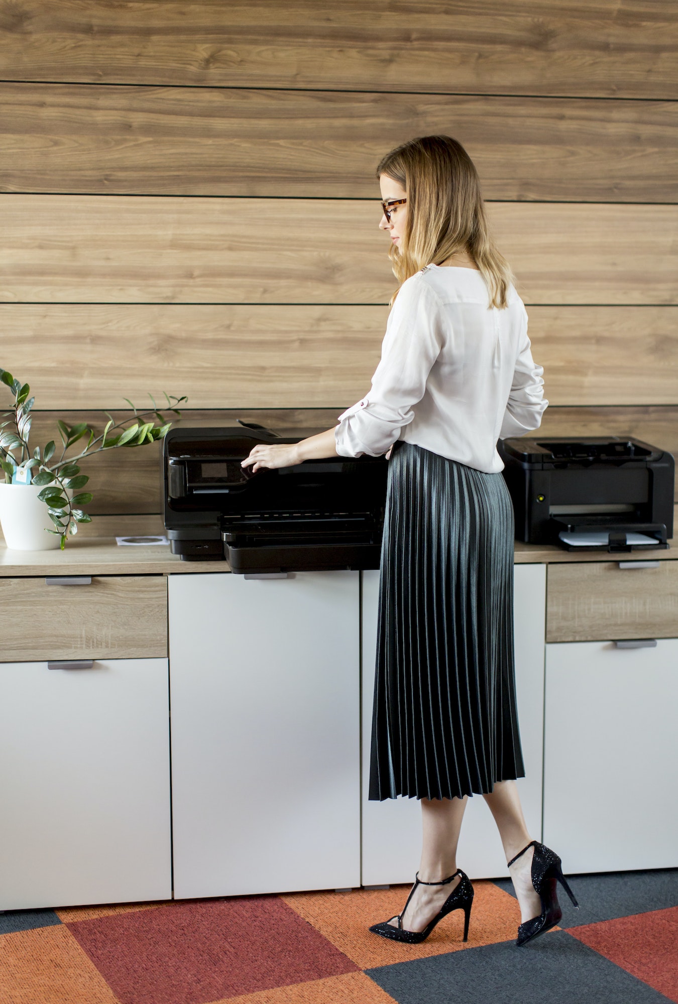 Business woman working in office by the printer Business woman working in office by the printer